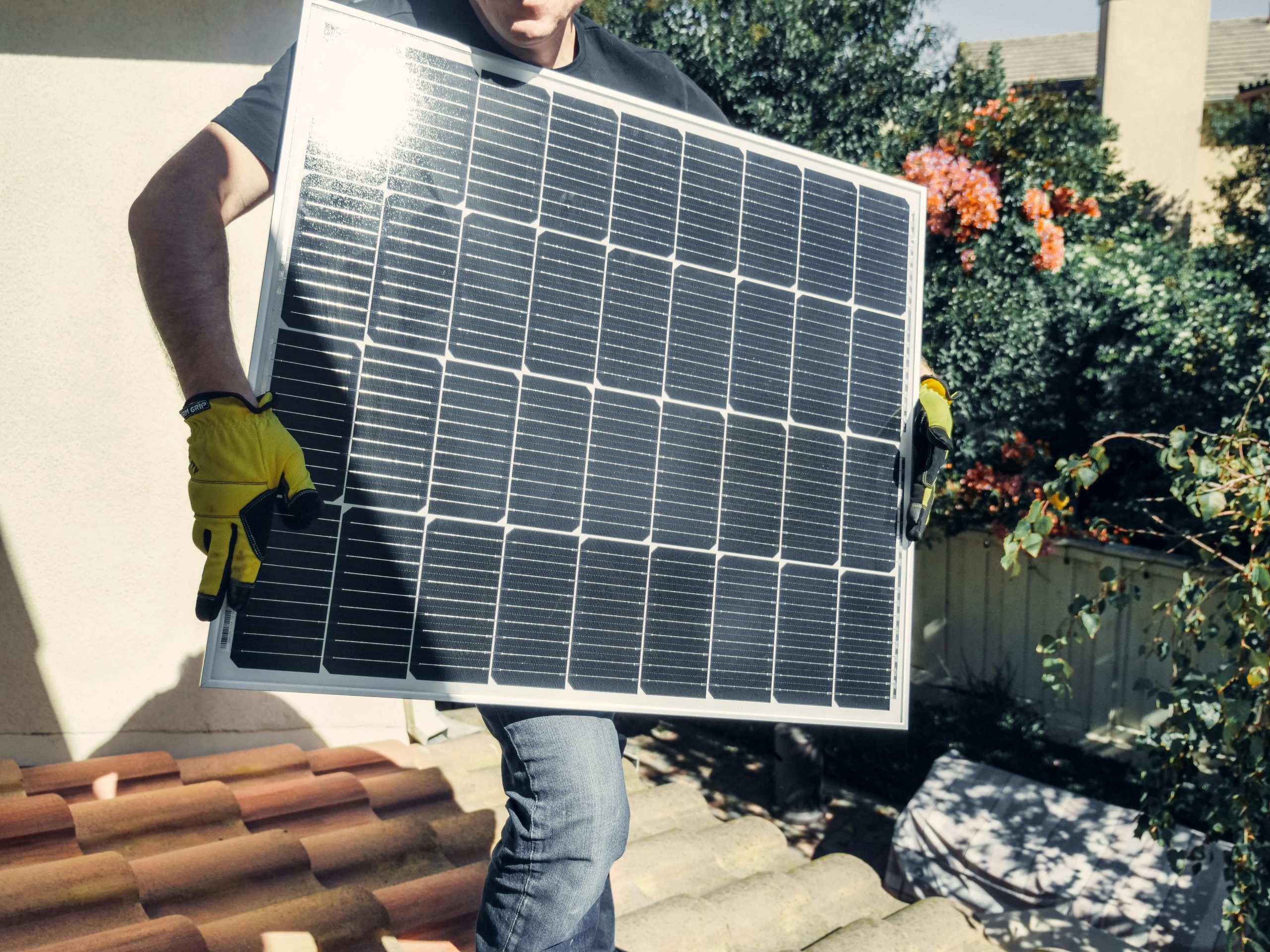 Installer carrying a solar panel
