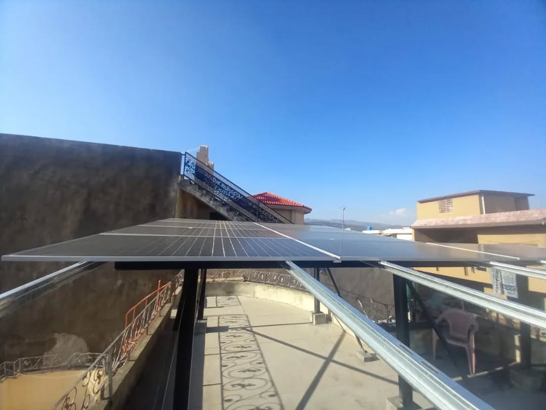 Rooftop solar array overlooking Islamabad hills